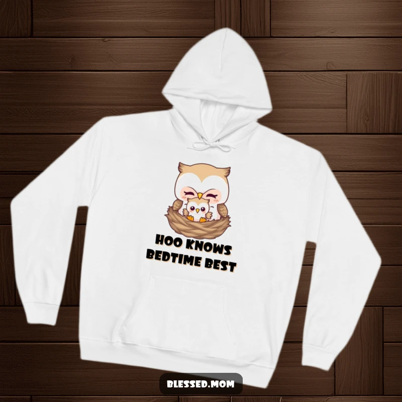 Funny hoodie depicting a mother owl tenderly tucking her baby owl into a nest, expressing love and security.